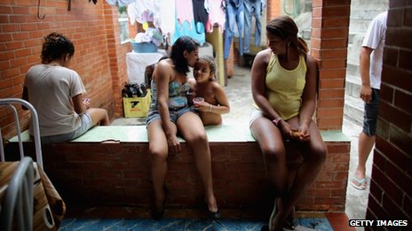 Members of the Das Neves family sit in their home in the Prazeres favela on 19 October, 2013