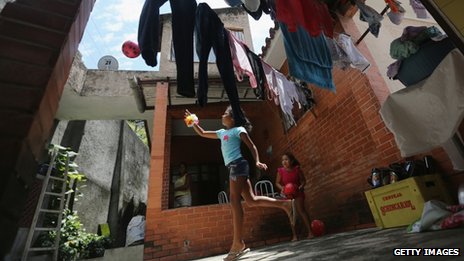 Members of the Das Neves family play in their home in the Prazeres favela on 19 October, 2013