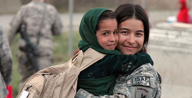 U.S. Army Spc. Jessica Walker from Killingworth, Conn., shares a hug with an Afghan child at a Girl Scout meeting on Forward Operating Base Finley Shields, Nangarhar province, Afghanistan, Oct 9. (U.S Army photo by Pfc. Cameron Boyd) 101009-A-1728B-202 http://www.flickr.com/photos/isafmedia/5080386066/