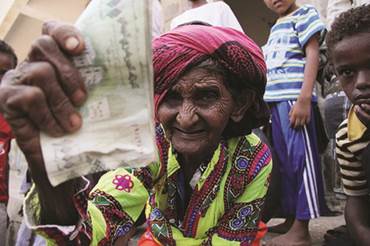 Woman receives a cash transfer lifeline in Yemen  some rights reserved by Oxfam International, 2012 (Flickr)