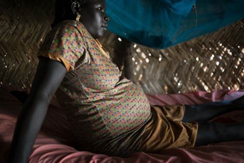 Kiir Adem, Northern Bahr el Ghazal, South Sudan/Sudan/No man s land, October 16, 2014: Aciriin Deng is 27 years old and seven months pregnant. Clean drinking water is a rare commodity in Kiir Adem and there is constant shoving and pushing near the boreholes in the area. The day before this pictures was taken, Aciriin was kicked in her back while queuing for water. Since then, her unborn baby has not moved. The nearest clinic is a day trip by away, driving on poor and sometimes impassable roads. But Aciriin has no money for transport and she does not know what will happen to her unborn child.