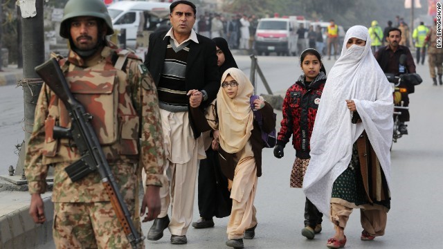 Parents escort their children away from a school attacked by the Taliban in Peshawar on Tuesday, December 16. Militants stormed the military-run school in northwest Pakistan, killing at least 130 people, most of them children. The Pakistan Taliban claimed responsibility for the attack, one of the bloodiest in the South Asian nation's history.