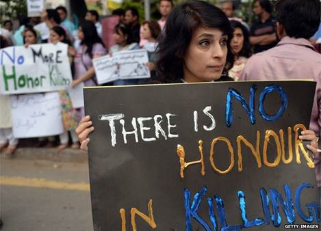 Pakistani human rights activists hold placards during a protest in Islamabad on May 29, 2014 against the killing of pregnant woman Farzana Parveen was beaten to death with bricks by members of her own family for marrying a man of her own choice in Lahore