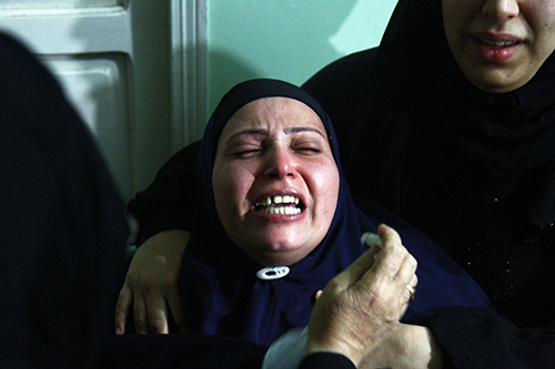 The mother of Egyptian journalist Mayada Ashraf mourns at her funeral. Ashraf was shot dead while covering clashes in eastern Cairo. (AFP/Ahmed Mahmoud)