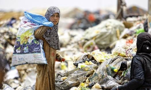 Iraq and Afghanistan accounted for 22% of all official development assistance (ODA) sent to fragile states and economies  an Iraqi girl searches through rubbish for recyclable items, Najaf, central Iraq.