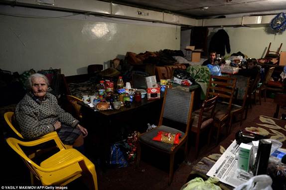 Local residents sit inside a makeshift bomb shelter in the eastern Ukrainian city of Debaltseve, in the rebellious Donetsk region