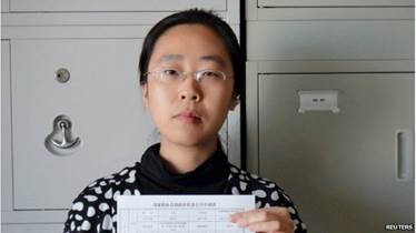 Women activist Wang Man, 32, poses with a paper in this undated file handout picture taken in an unknown location in China, provided by a women's rights group on 8 April 2015.