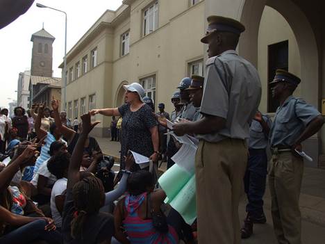 Jenni Williams (in white cap) addresses Women of Zimbabwe Arise members at Zimbabwes parliament building in Harare with the police looking on. Zimbabwe is one of the African countries where repression of civic freedoms appears to have intensified. Credit: Misheck Rusere/IPS