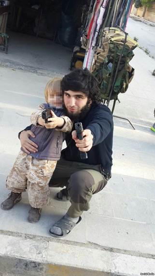 Mansur Shishani and a toddler posing with guns