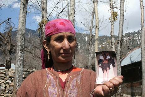 A woman holds up a picture of her son, injured in the conflict. Here in Kashmir, women often bear the brunt of fighting and some have been subjected to rape at the hands of the armed forces. Credit: Athar Parvaiz/IPS