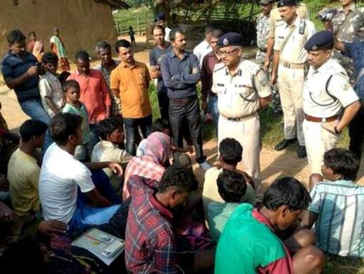 Indian police talk to villagers after five women were killed as they accused of practicing witchcraft