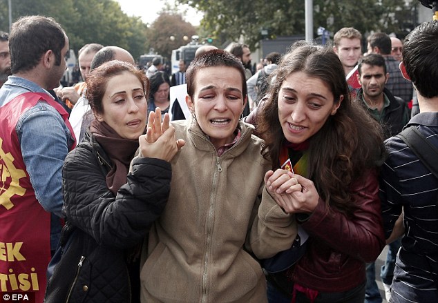 Distraught: A woman mourns for victims as her friends comfort her during a demonstration one day after the double explosion in Ankara